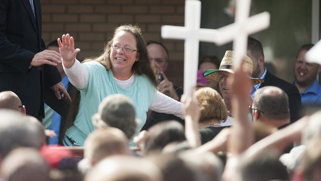 Rowan County Clerk of Courts Kim Davis waves to a crowd of her supporters at a rally in front of the Carter County Detention Center in Grayson, Ky., on Sept. 8, 2015. Davis was ordered to jail last week for contempt of court after refusing a court order to issue marriage licenses to same-sex couples.
