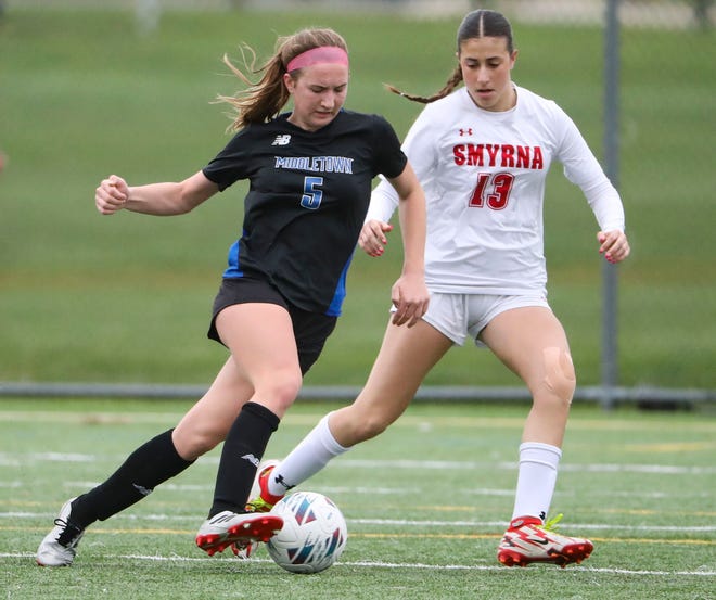 Middletown's Flannery Grimm (left) tries to move past Smyrna's Emily Dunlop in the first half of the Cavaliers' 5-0 win at Middletown, Thursday, March 28, 2024.
