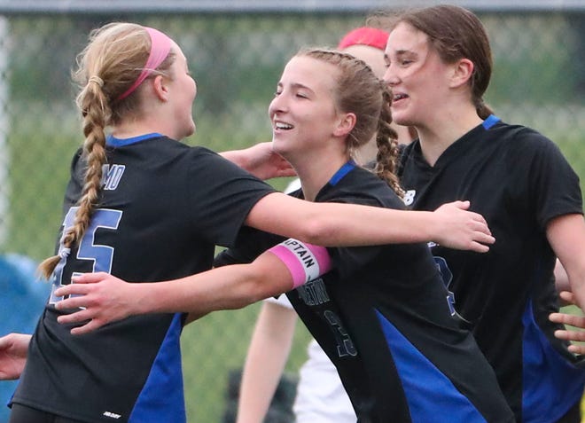 Middletown's (from left) Cara Cimo, Gabriella Riley and Lily Holcroft celebrate a goal by Holcroft in the first half of the Cavaliers' 5-0 win at Middletown, Thursday, March 28, 2024.