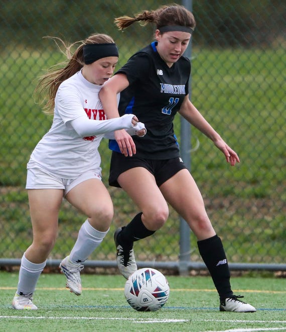 Smyrna's Kaelyn Mickulus (left) and Middletown's Jaqueline McKenna vie for the ball in the second half of the Cavaliers' 5-0 win at Middletown, Thursday, March 28, 2024.