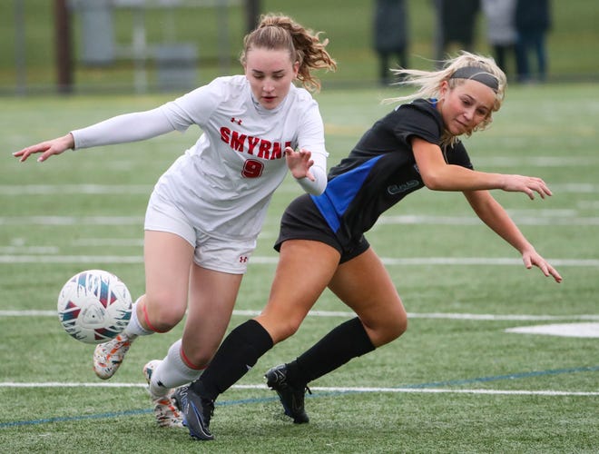Smyrna's Peyton Macfarlane (left) tangles with Middletown's Madison Yarborough in the second half of the Cavaliers' 5-0 win at Middletown, Thursday, March 28, 2024.