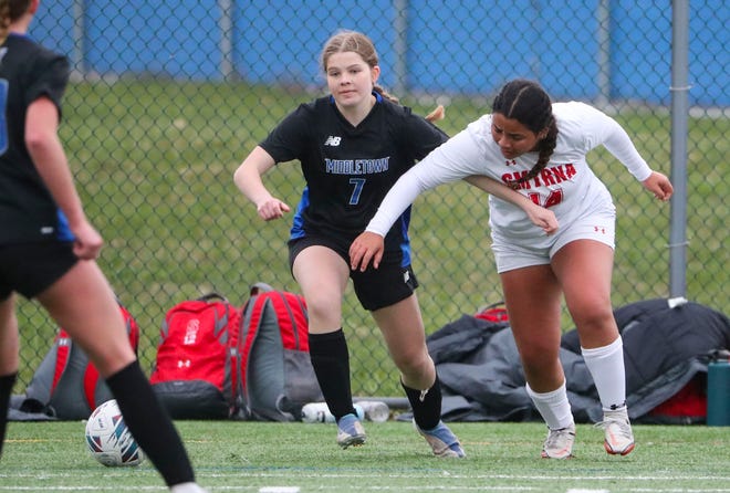 Middletown's Drew Cimo (left) tries to move past Smyrna's Jocelyn Tejeda in the second half of the Cavaliers' 5-0 win at Middletown, Thursday, March 28, 2024.