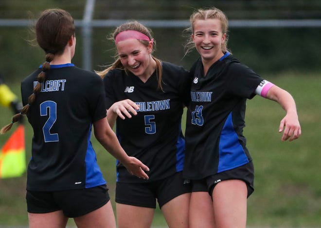 Middletown's (from left) Lily Holcroft, Flannery Grimm and Gabriella Riley celebrate Grimm's score, the last goal of the day late in the Cavaliers' 5-0 win against Smyrna at Middletown, Thursday, March 28, 2024. The trio provided all five goals in the game, with Holcroft and Riley each netting two.