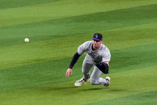 Rockies outfielder Brenton Doyle is unable to make a diving catch against the Arizona Diamondbacks.