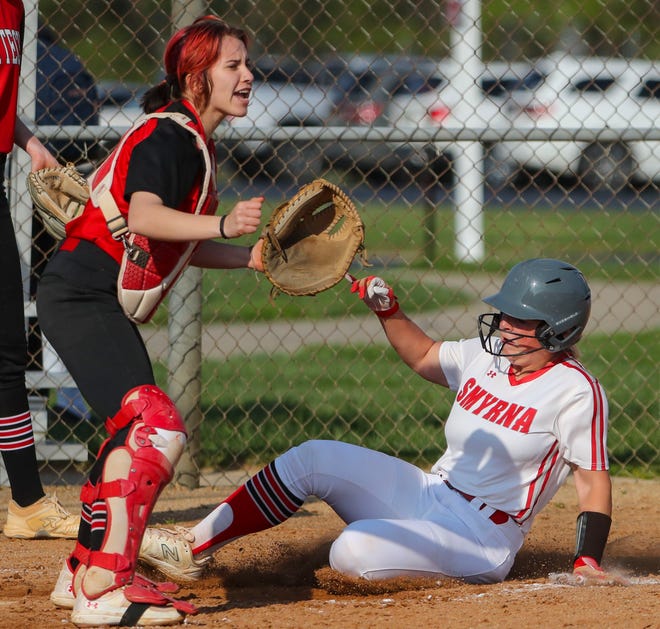 Smyrna's Adison Weisenberger scores in front of Polytech catcher Brianna Benton in the fourth inning of Polytech's 8-3 win at Smyrna High School, Thursday, April 18, 2024.