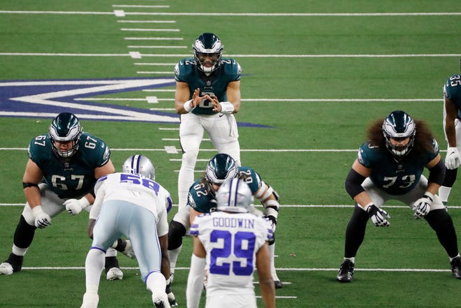 Philadelphia Eagles quarterback Jalen Hurts (2) waits for the snap along with guard Nate Herbig (67) and guard Isaac Seumalo (73) in the second half of an NFL football game in Arlington, Texas, Sunday, Dec. 27. 2020. (AP Photo/Roger Steinman)
