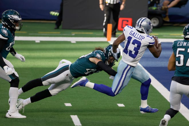 Dallas Cowboys wide receiver Michael Gallup (13) avoids the tackle attempt of Philadelphia Eagles linebacker Alex Singleton (49) for a touchdown in the first half of an NFL football game in Arlington, Texas, Sunday, Dec. 27. 2020. (AP Photo/Ron Jenkins)
