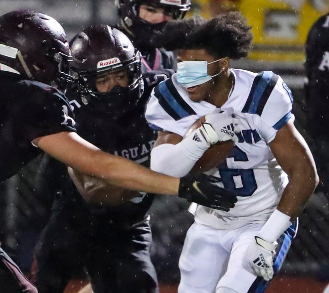 Middletown's Zy'Aire Tart keeps running despite losing his helmet and his mask shifting over his eyes in Middletown's 21-0 win at Appoquinimink in early December.
