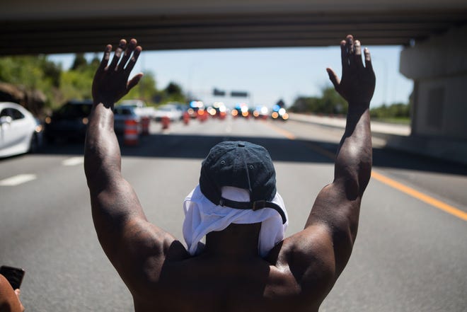 Protestors demonstrate on I-95 in front of Delaware State Police in response to the death of George Floyd Saturday, May 30, 2020, in Wilmington.