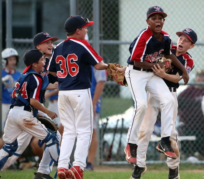 M.O.T.'s (from left) Connor Fitzgerald, Logan Peters, Cole Simpson, Emmett Robinson and Cole Blanton celebrate after Robinson recorded the final out by strikeout as M.O.T. beat Canal 7-6 to win the Major state Little League title in August.